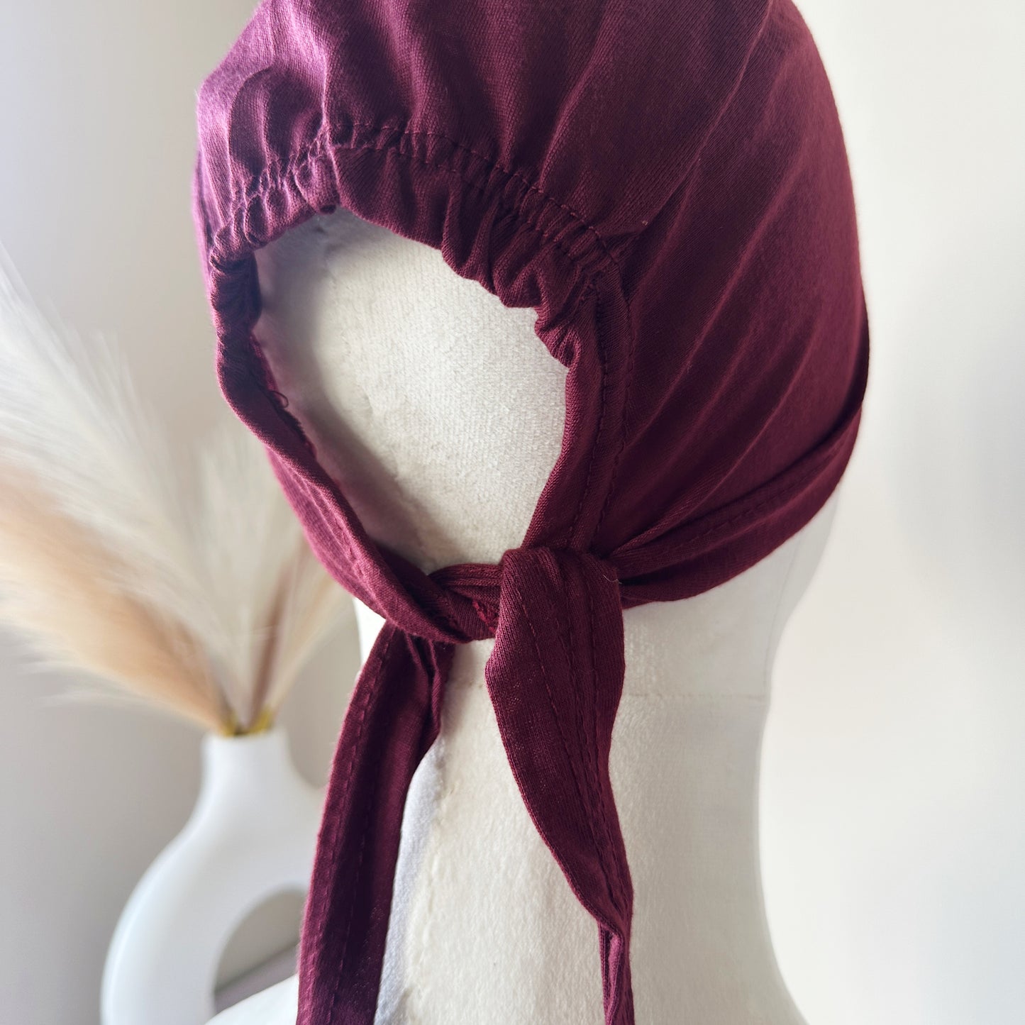 Hijab cap displayed flat with tie straps extended