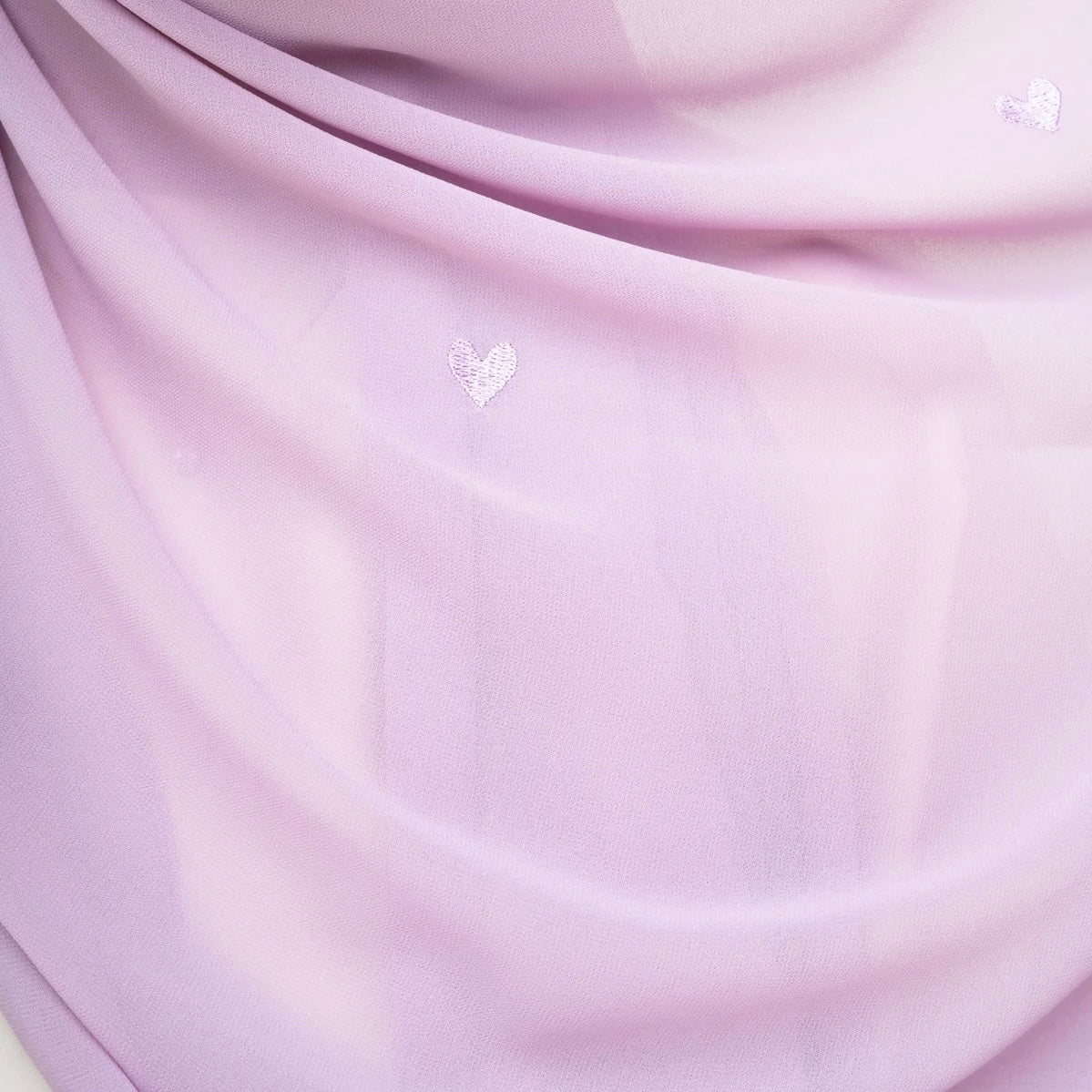 Model wearing purple heart-embroidered chiffon hijab for modest wear