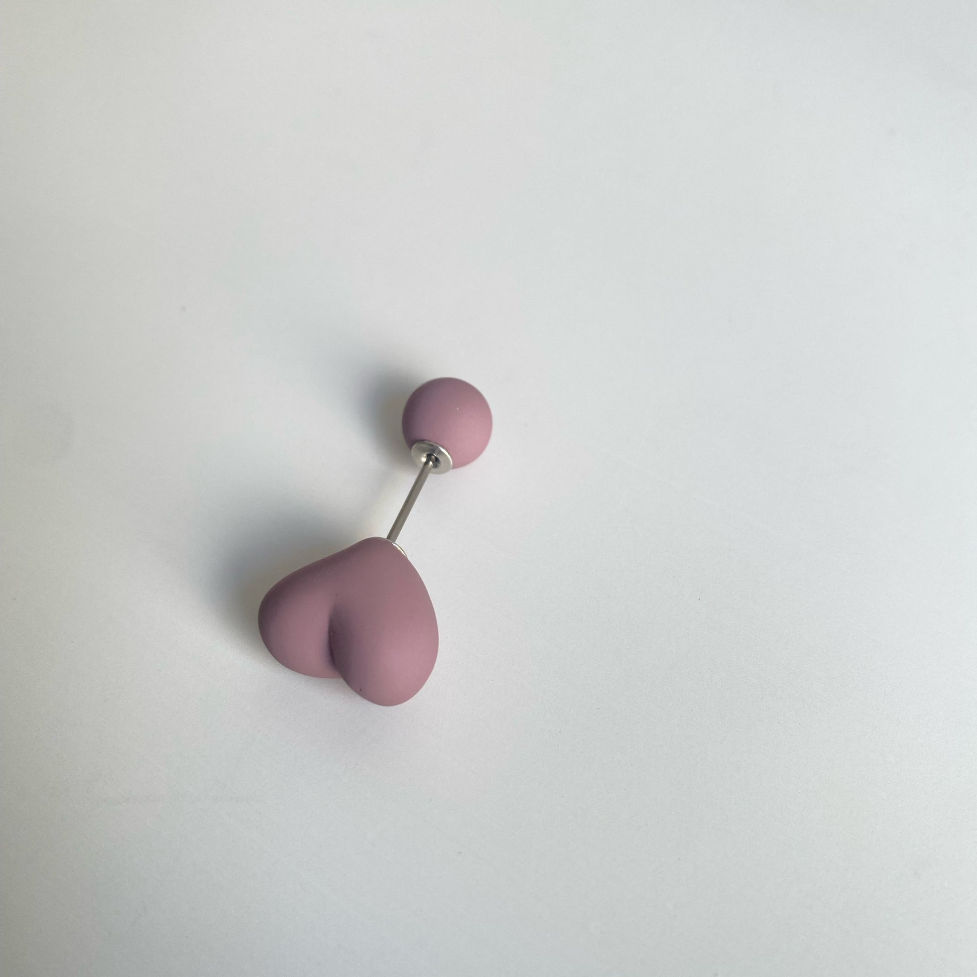 Red heart hijab pin placed on soft jersey scarf – secure and snag-free – Hijabaan