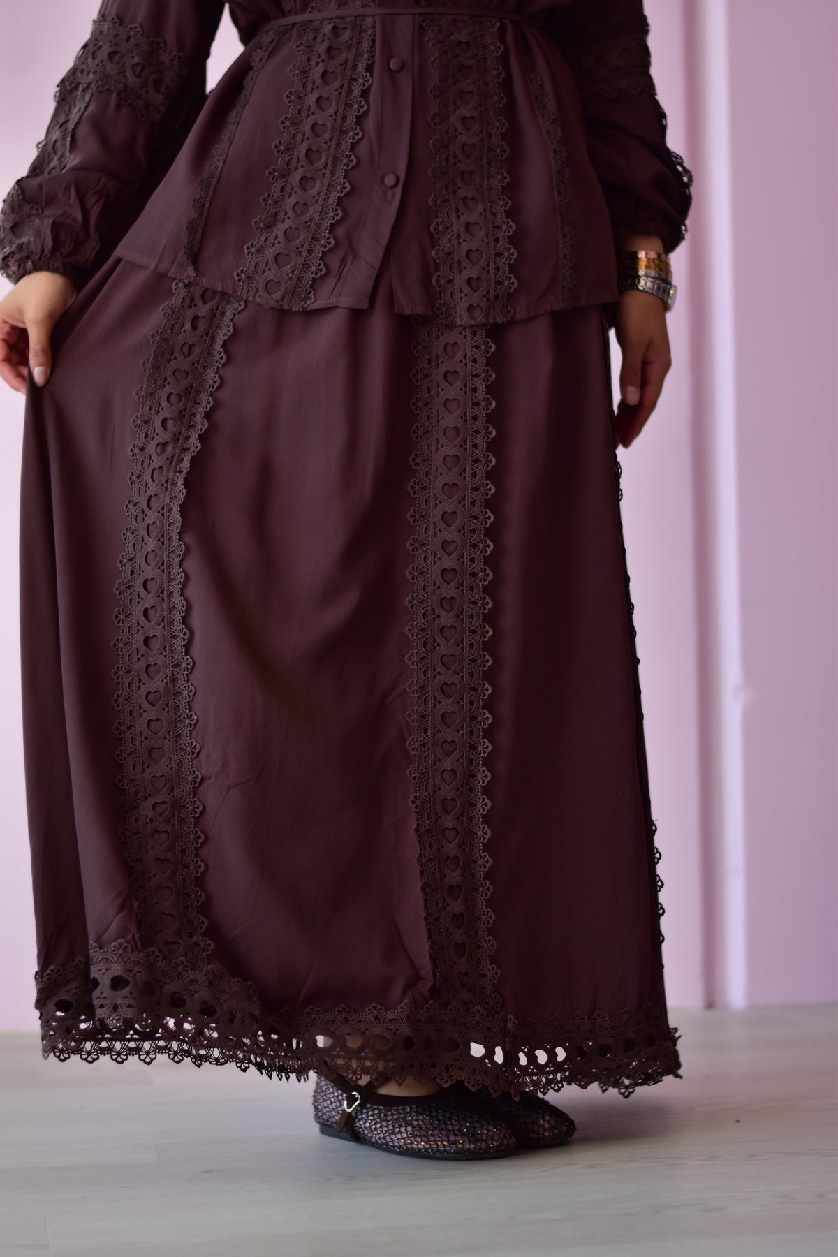 Amira brown co-ord skirt showing the pockets and matching ribbon belt