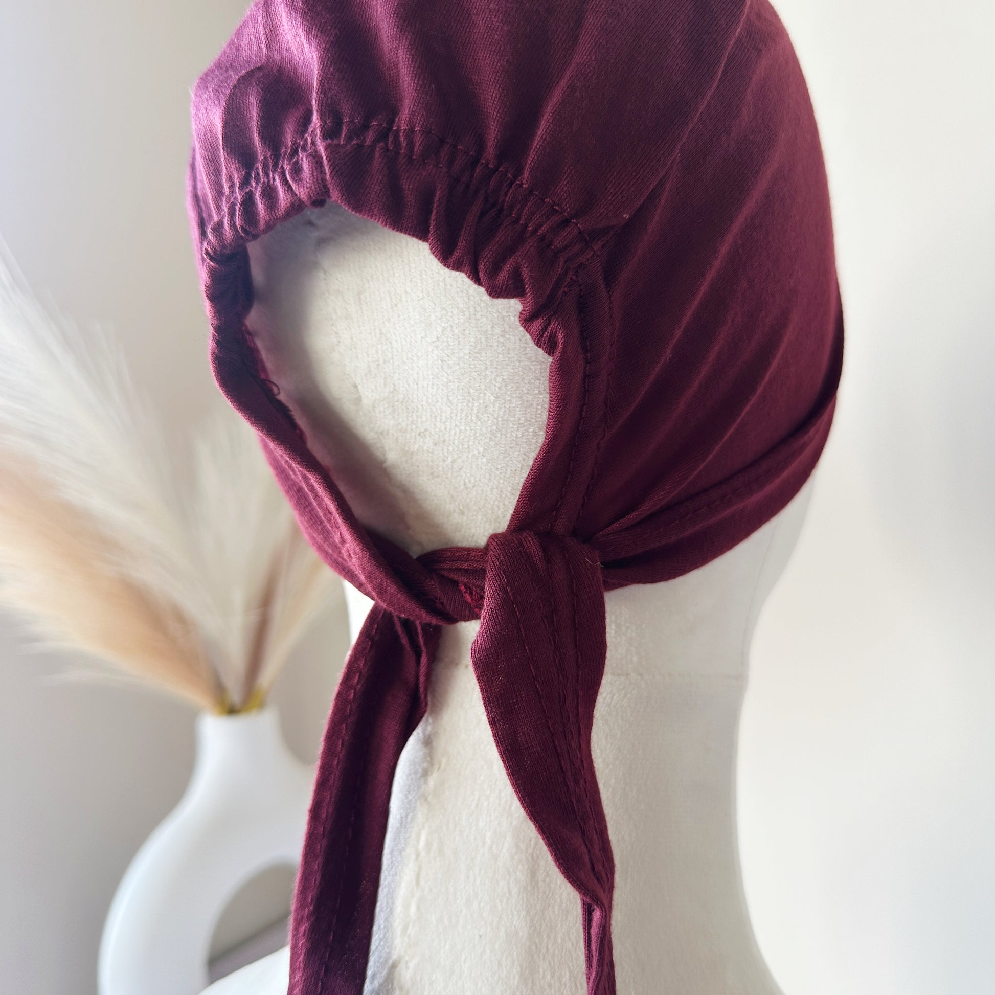 Hijab cap displayed flat with tie straps extended